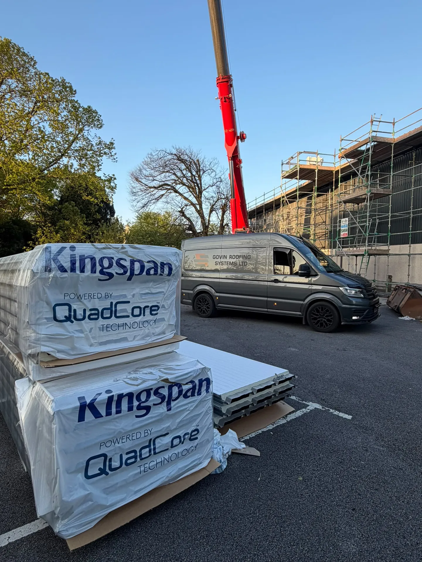 Govin Roofing Systems van on site with Kingspan QuadCore roof panels and crane